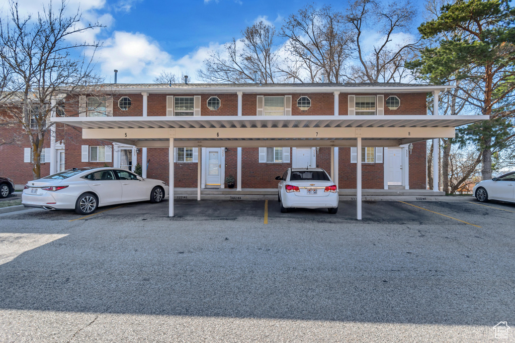 View of building exterior with covered parking