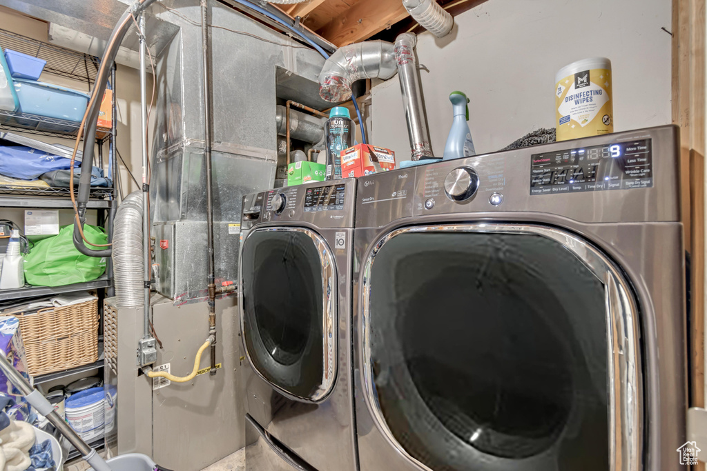 Washroom featuring washer and dryer and laundry area
