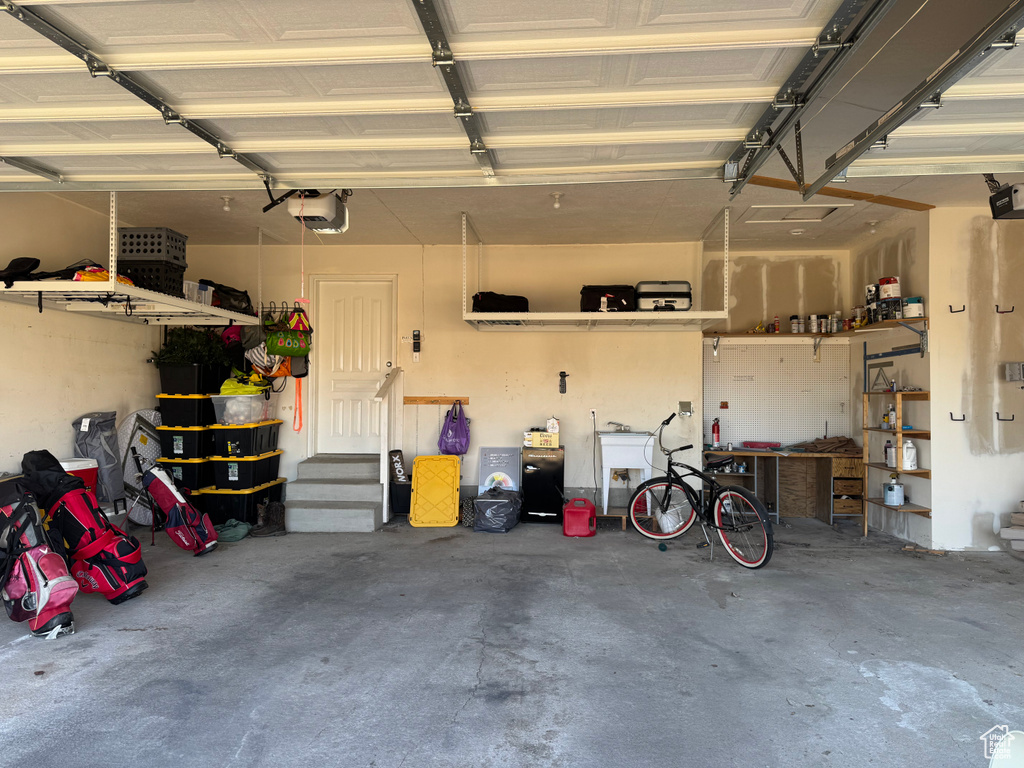Garage with a workshop area and a garage door opener