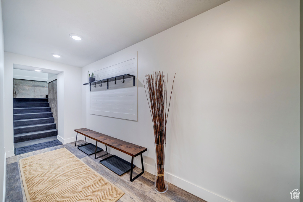 Interior space with baseboards, light wood finished floors, and recessed lighting