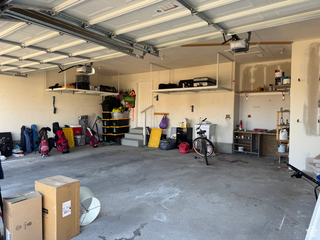 Garage featuring a workshop area and a garage door opener