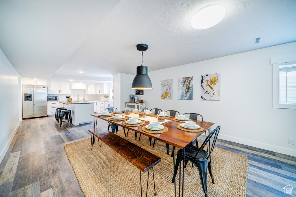 Dining space with baseboards and wood finished floors