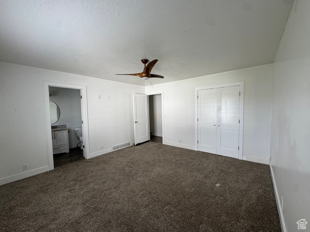 Unfurnished bedroom with visible vents, baseboards, ensuite bathroom, and carpet