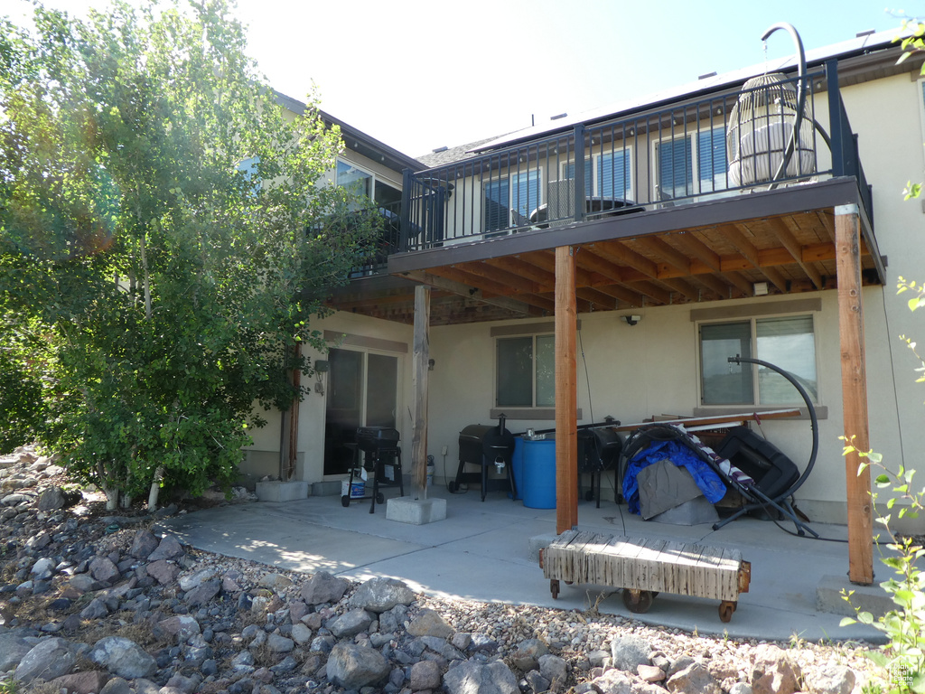 Back of house featuring stucco siding and a patio area