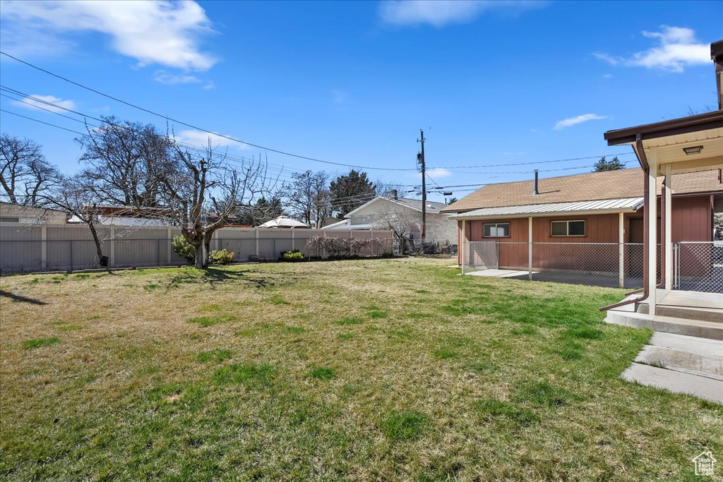 View of yard featuring fence