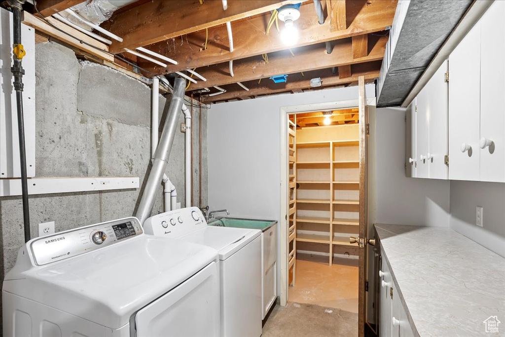 Laundry room featuring washer and dryer and cabinet space