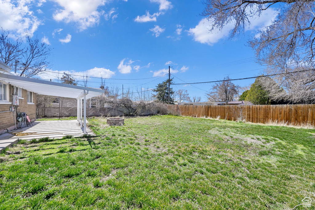View of yard with a fenced backyard and a patio area