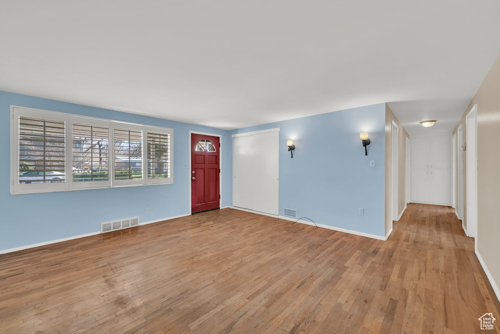Entrance foyer featuring baseboards, visible vents, and wood-type flooring