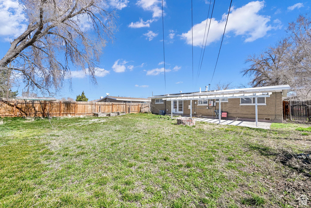 View of yard featuring a patio and a fenced backyard