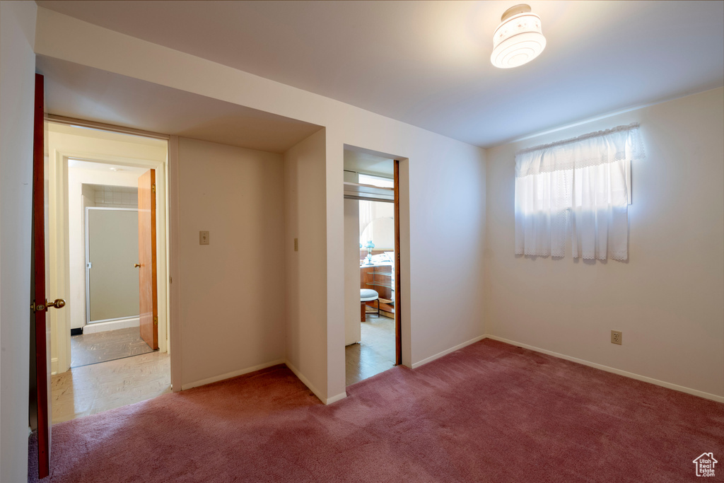 Unfurnished bedroom with carpet and baseboards