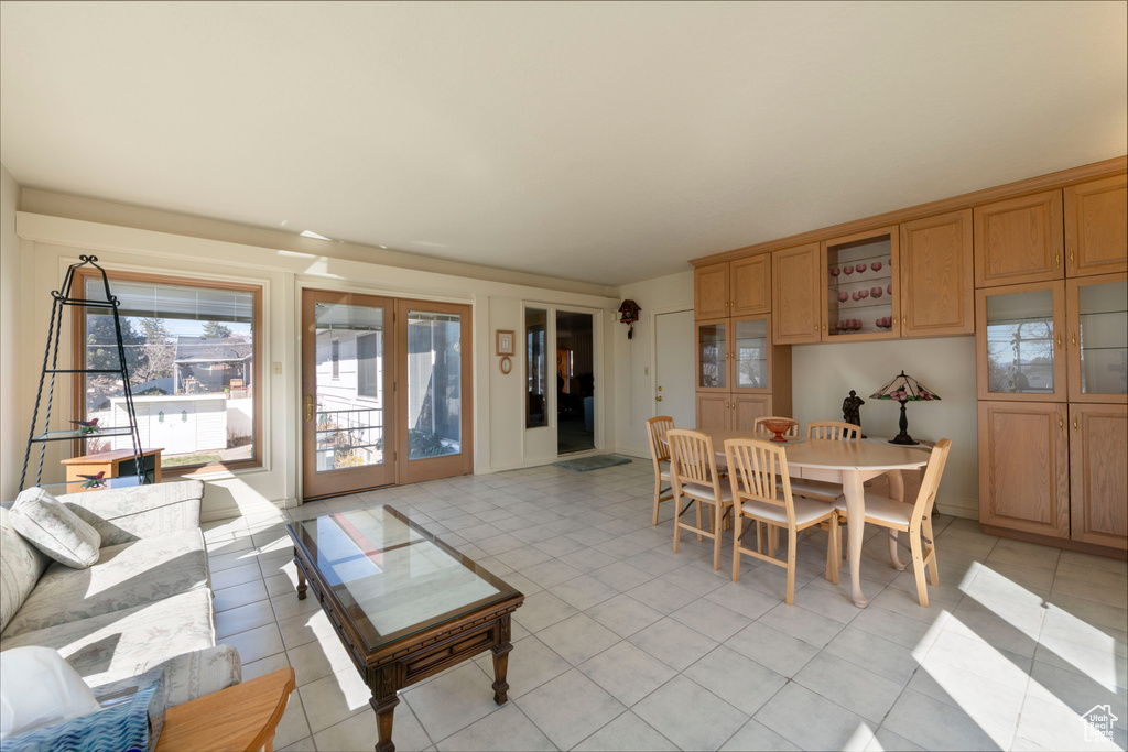 Dining area with light tile patterned floors