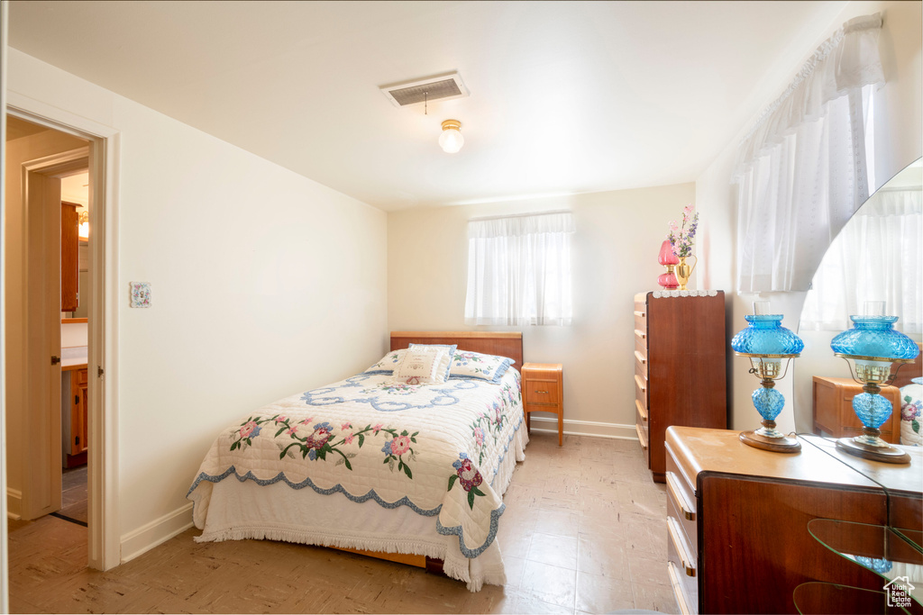 Bedroom featuring baseboards and visible vents