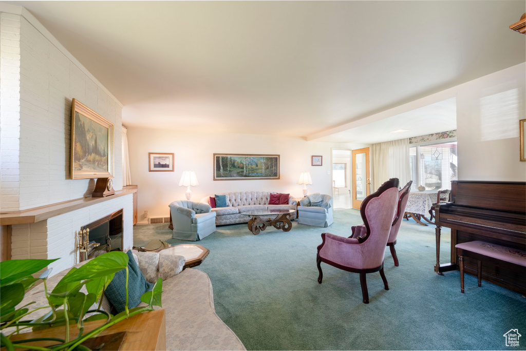 Carpeted living area featuring a fireplace