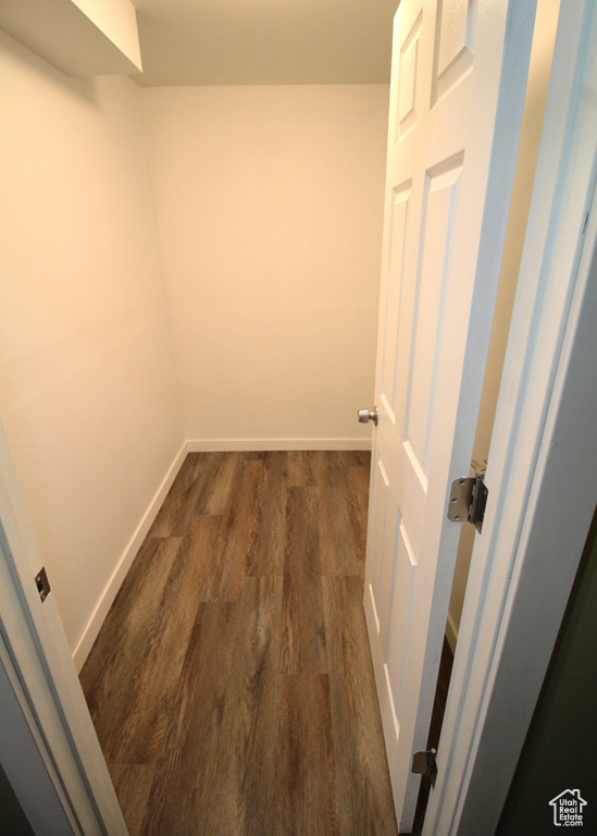 Spacious closet with dark wood-style floors