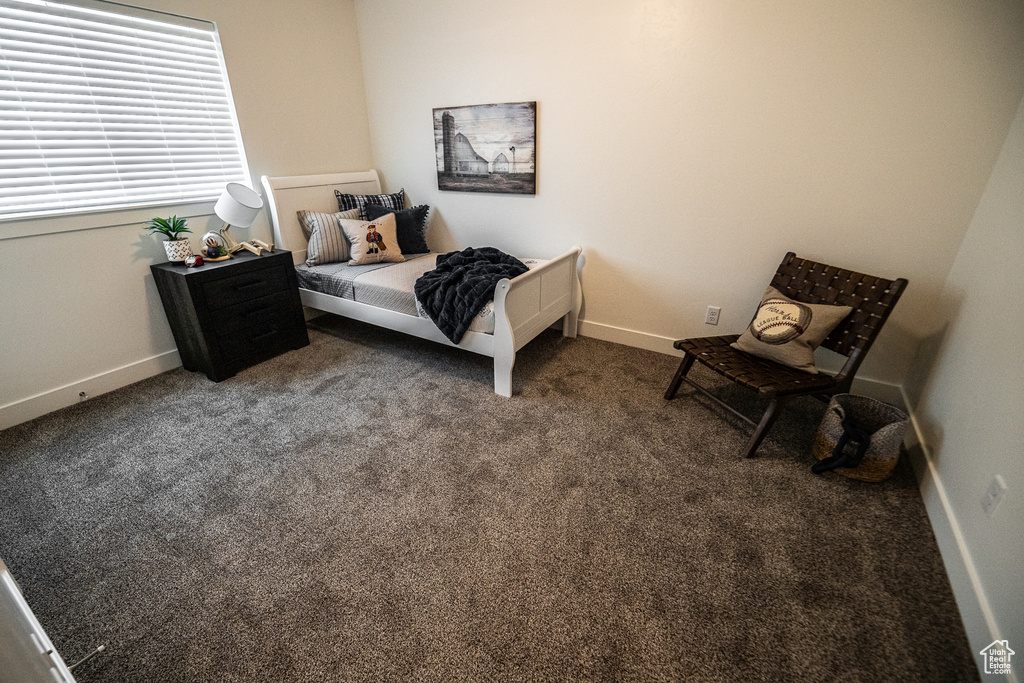 Carpeted bedroom featuring baseboards