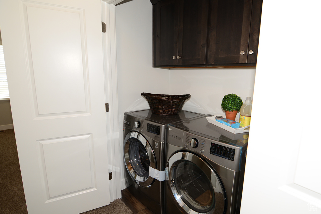 Washroom featuring cabinet space and independent washer and dryer