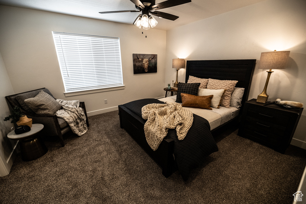 Bedroom with baseboards, carpet flooring, and a ceiling fan