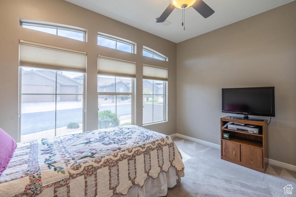 Bedroom featuring baseboards, ceiling fan, and carpet floors