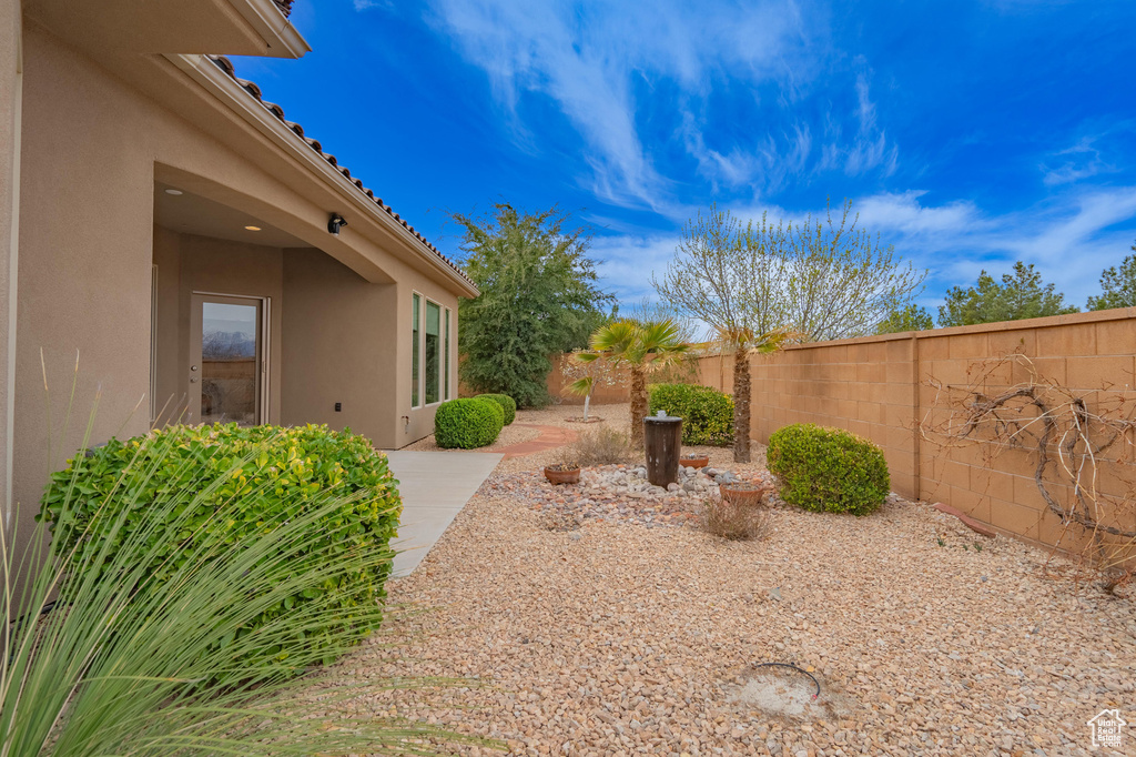 View of yard with a fenced backyard and a patio