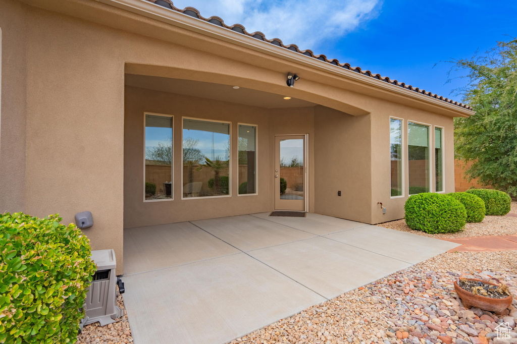 Rear view of property with stucco siding and a patio