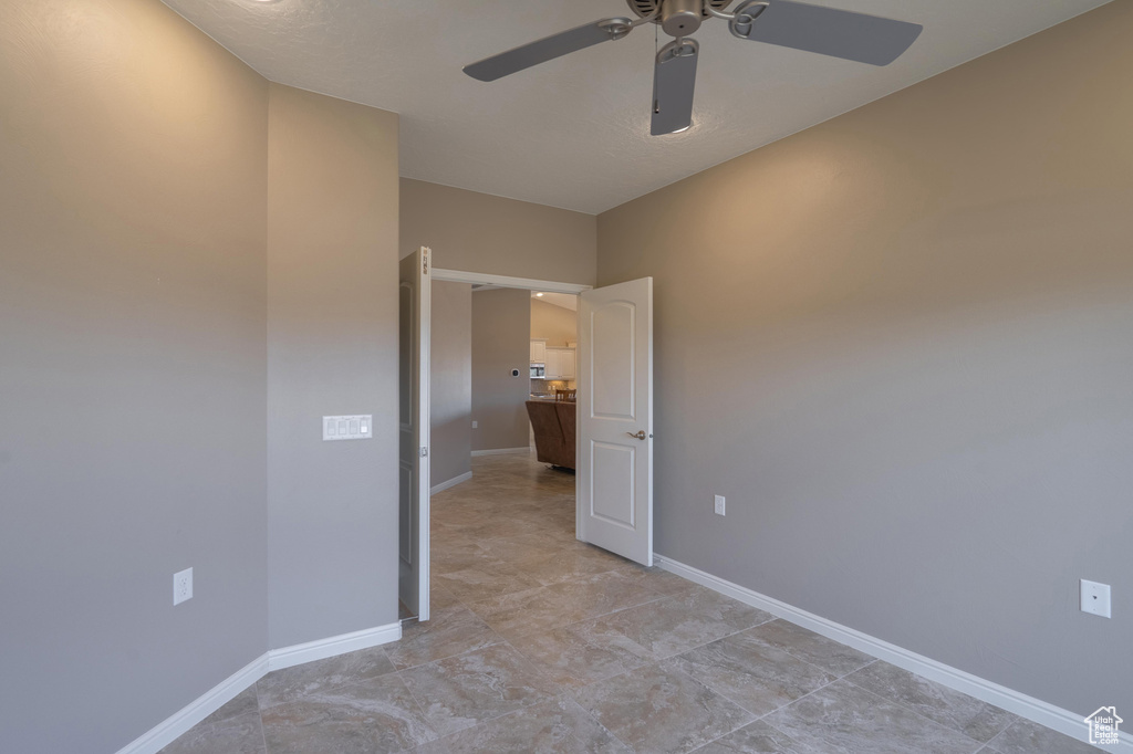 Unfurnished bedroom featuring baseboards and ceiling fan