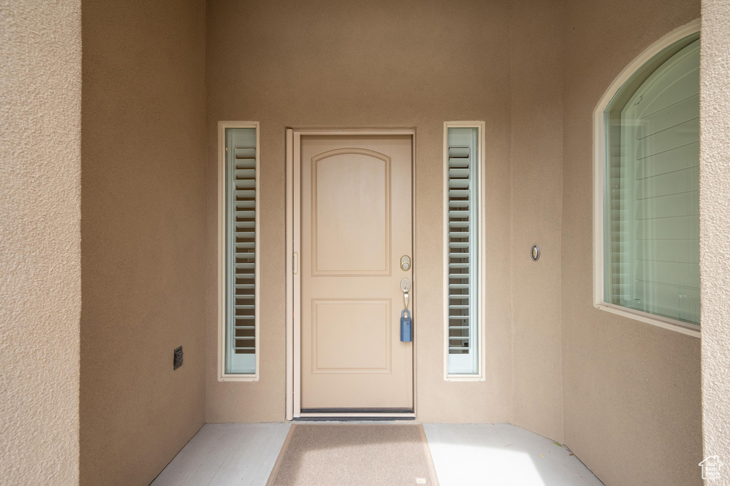 View of exterior entry with stucco siding