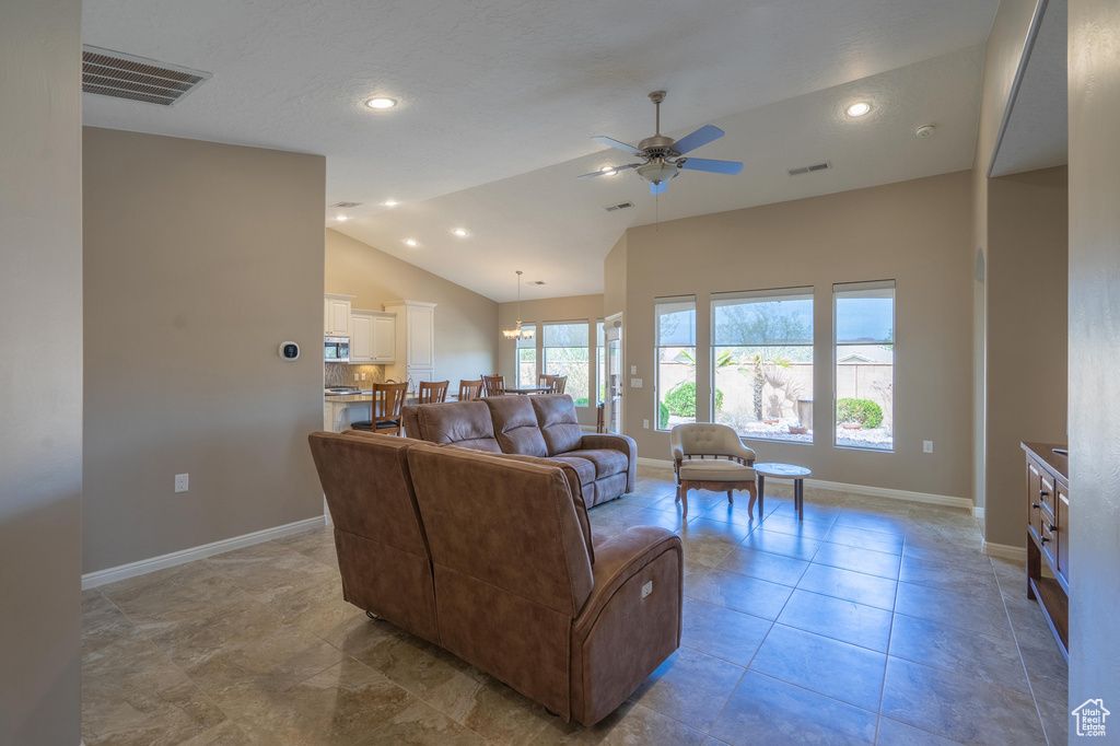 Living room featuring baseboards, visible vents, ceiling fan, and recessed lighting
