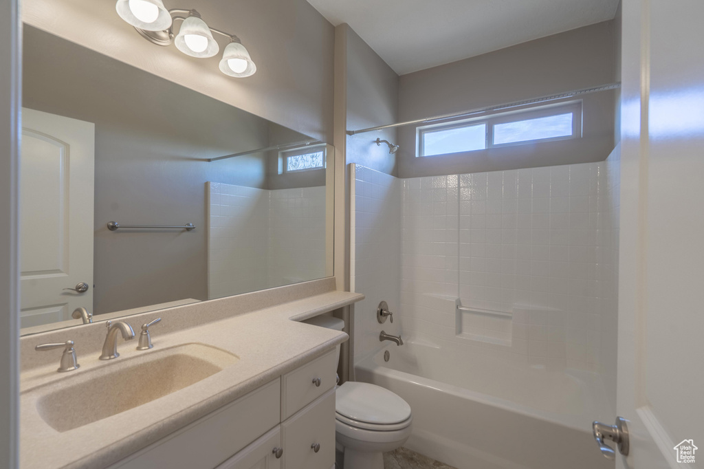 Bathroom with toilet, vanity, and shower / bathing tub combination