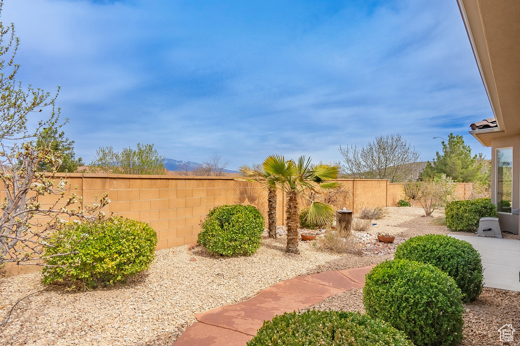 View of yard featuring a fenced backyard and a patio