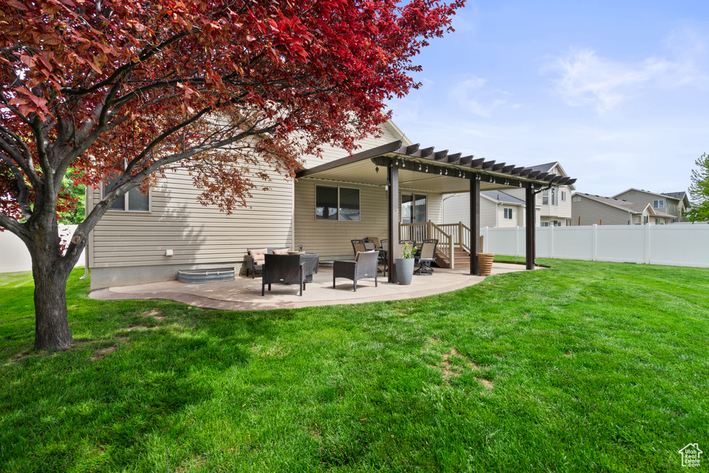 Rear view of house featuring a pergola and a patio