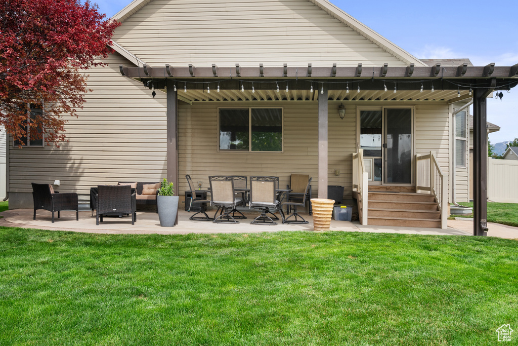 Back of property with a patio, entry steps, and outdoor lounge area
