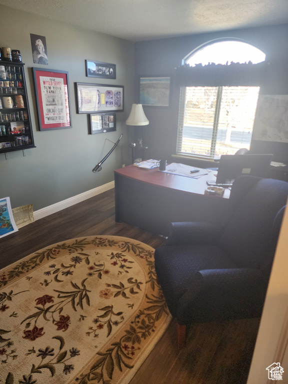 Office space with baseboards and wood finished floors