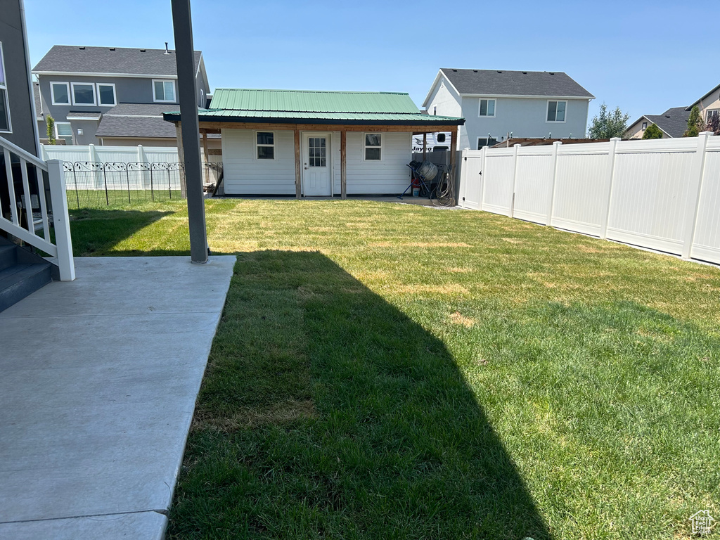 Fenced backyard with a patio
