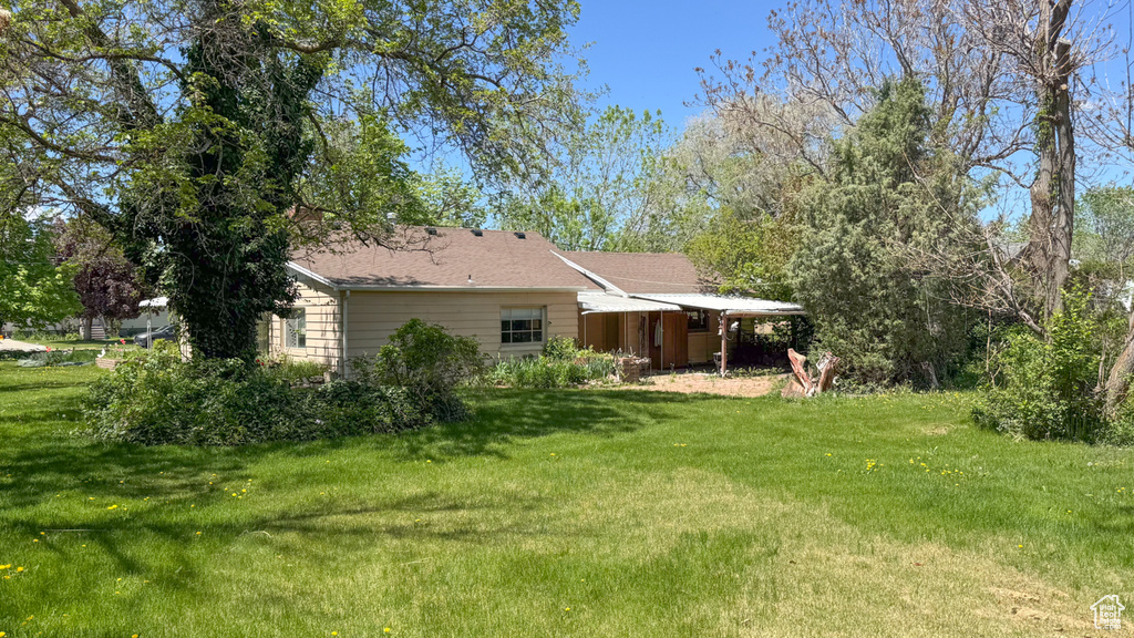 Back of house with a lawn