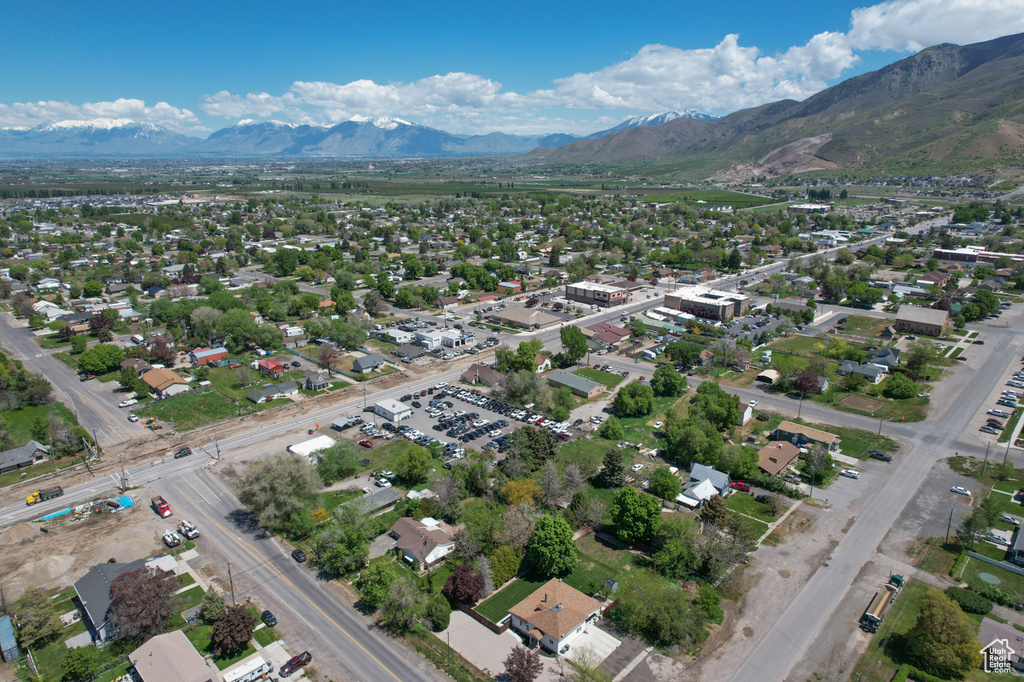 Aerial view of property and surrounding area with a mountainous background