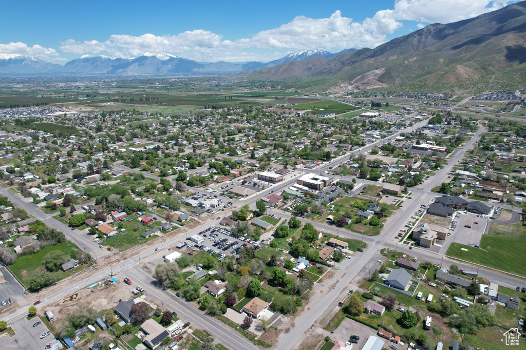 Aerial view of property's location featuring a mountainous background