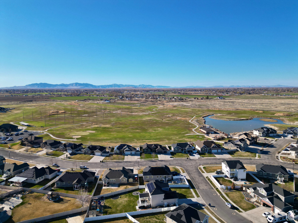 Birds eye view of property featuring a water and mountain view and a residential view