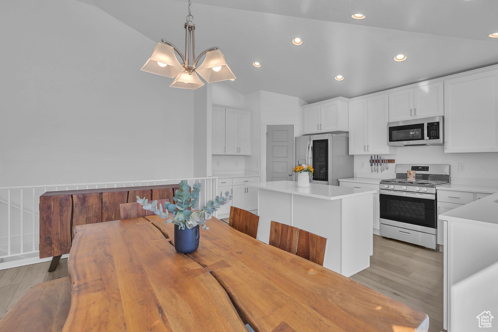 Dining space featuring vaulted ceiling, recessed lighting, and light wood finished floors