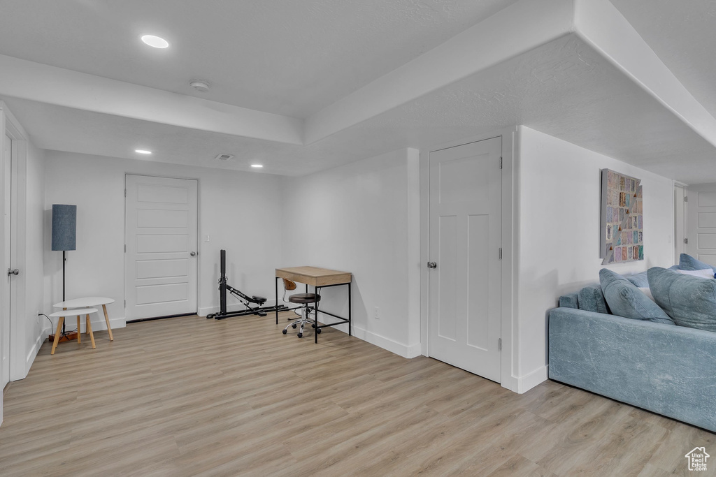 Interior space featuring baseboards, recessed lighting, and light wood-style floors