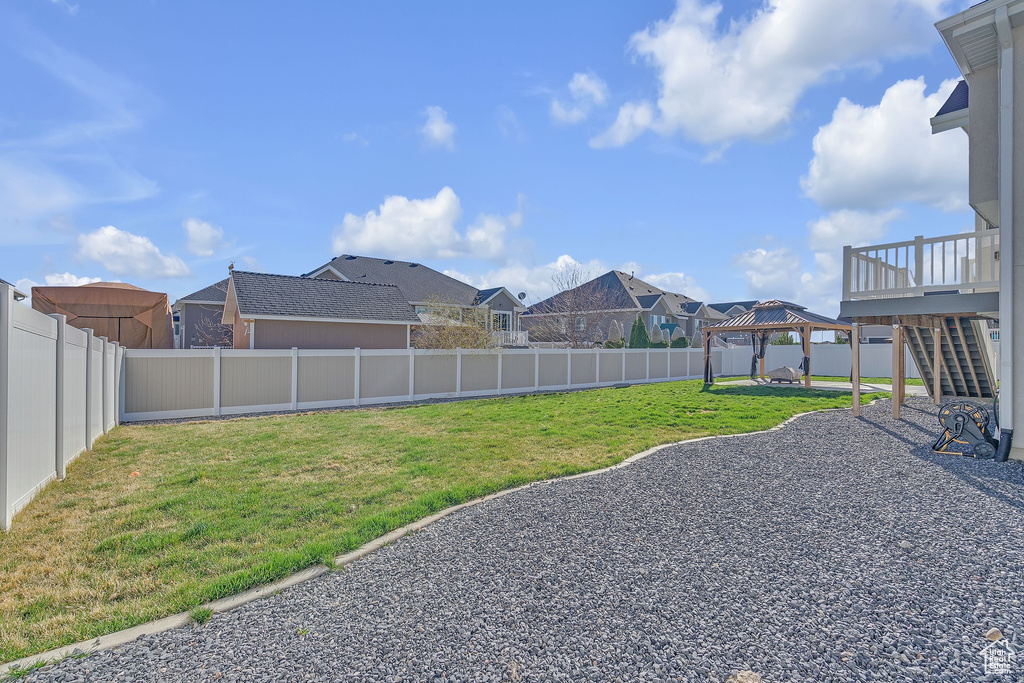 View of yard with a fenced backyard and a gazebo