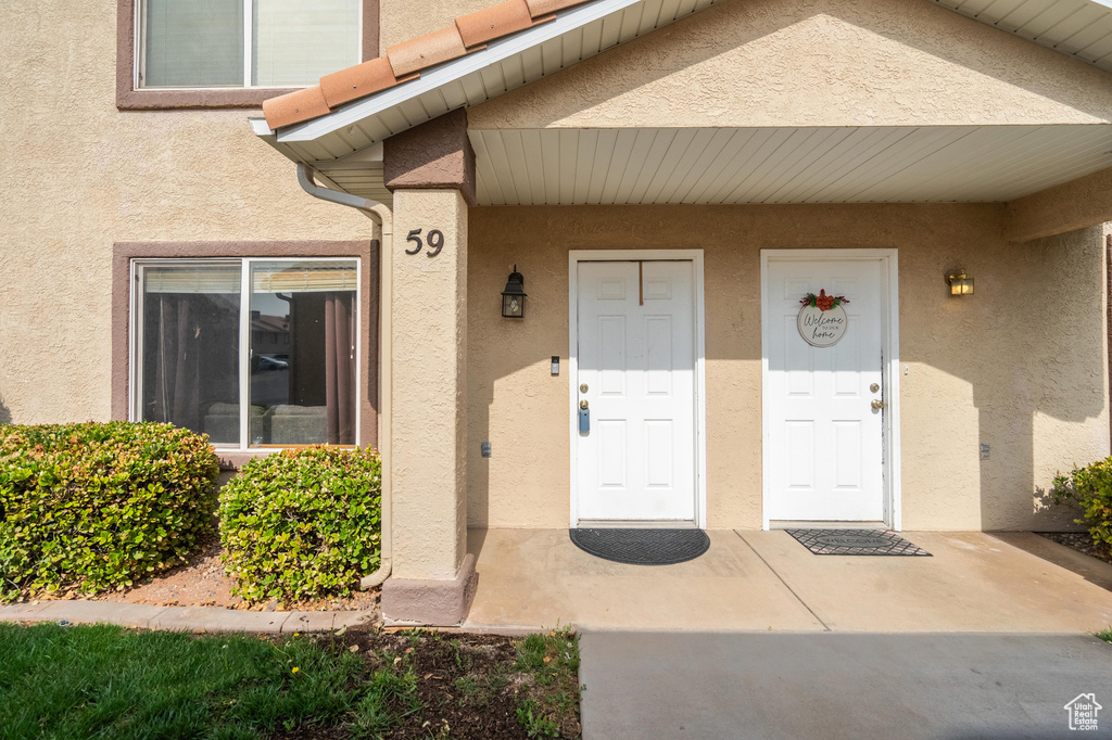 Entrance to property featuring stucco siding
