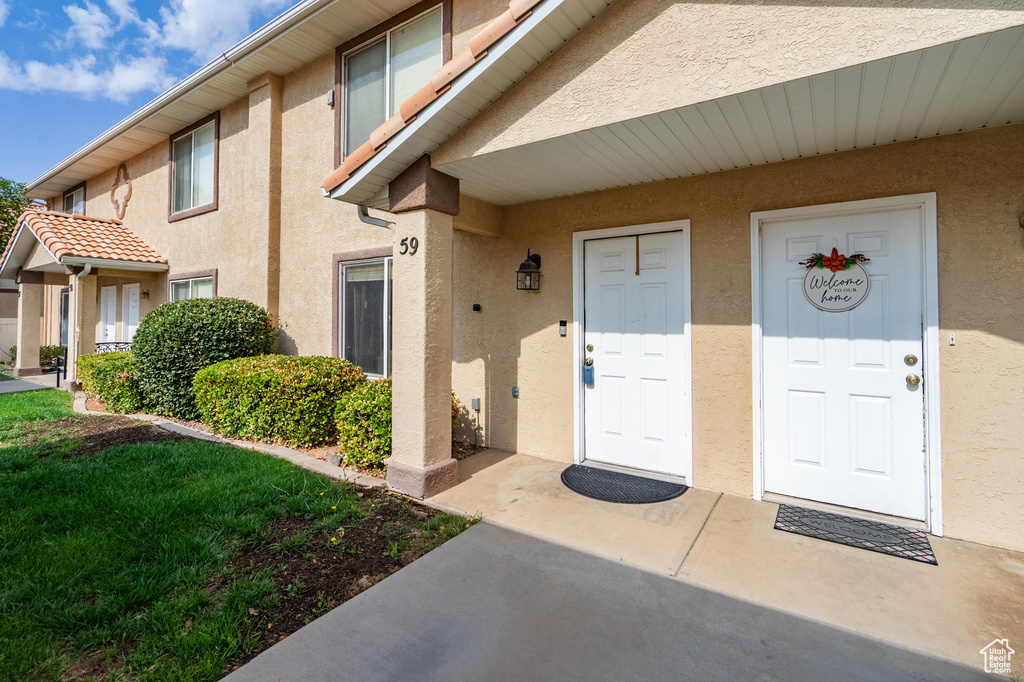 Doorway to property with stucco siding