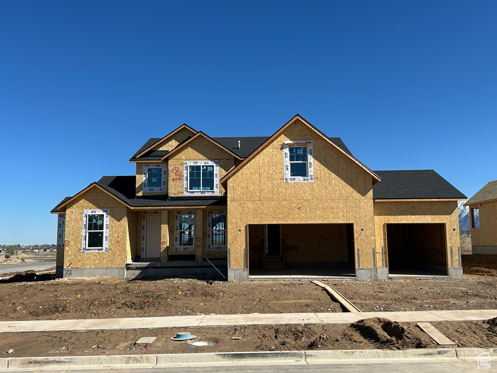 Unfinished property featuring a garage and a porch