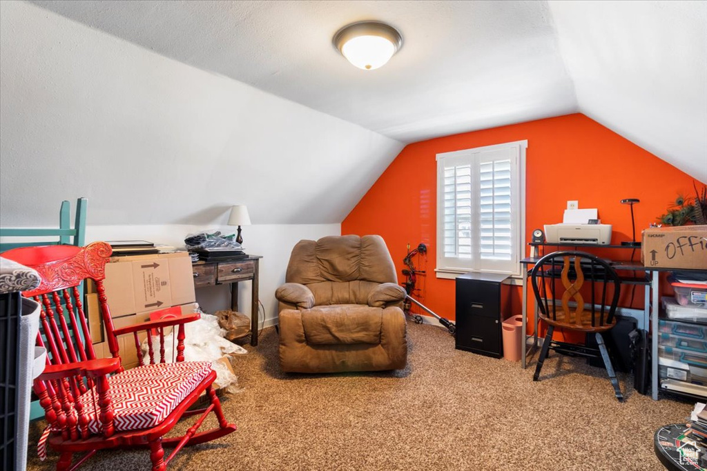 Carpeted home office featuring lofted ceiling