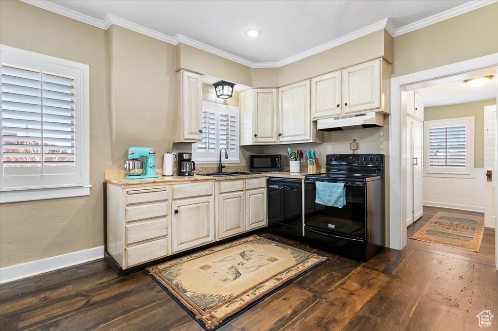 Kitchen with a sink, under cabinet range hood, black appliances, and dark wood-style flooring