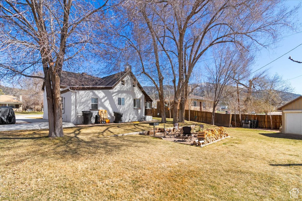 View of yard with a patio and fence