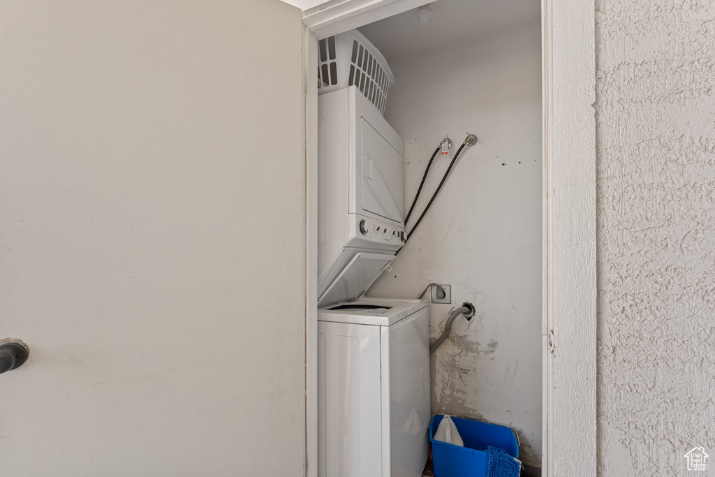 Laundry room with stacked washing maching and dryer and laundry area