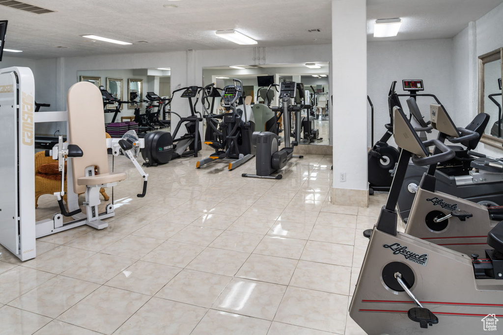 Exercise room featuring tile patterned floors and visible vents