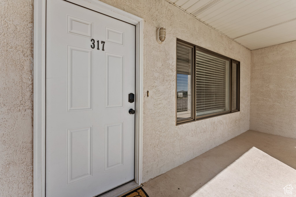 Entrance to property featuring stucco siding