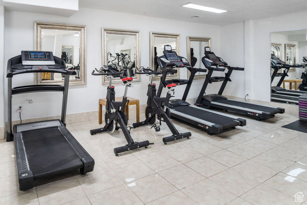 Exercise room featuring tile patterned floors